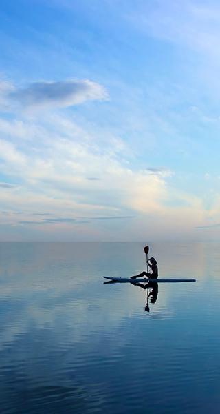 person kayaking peaceful lake